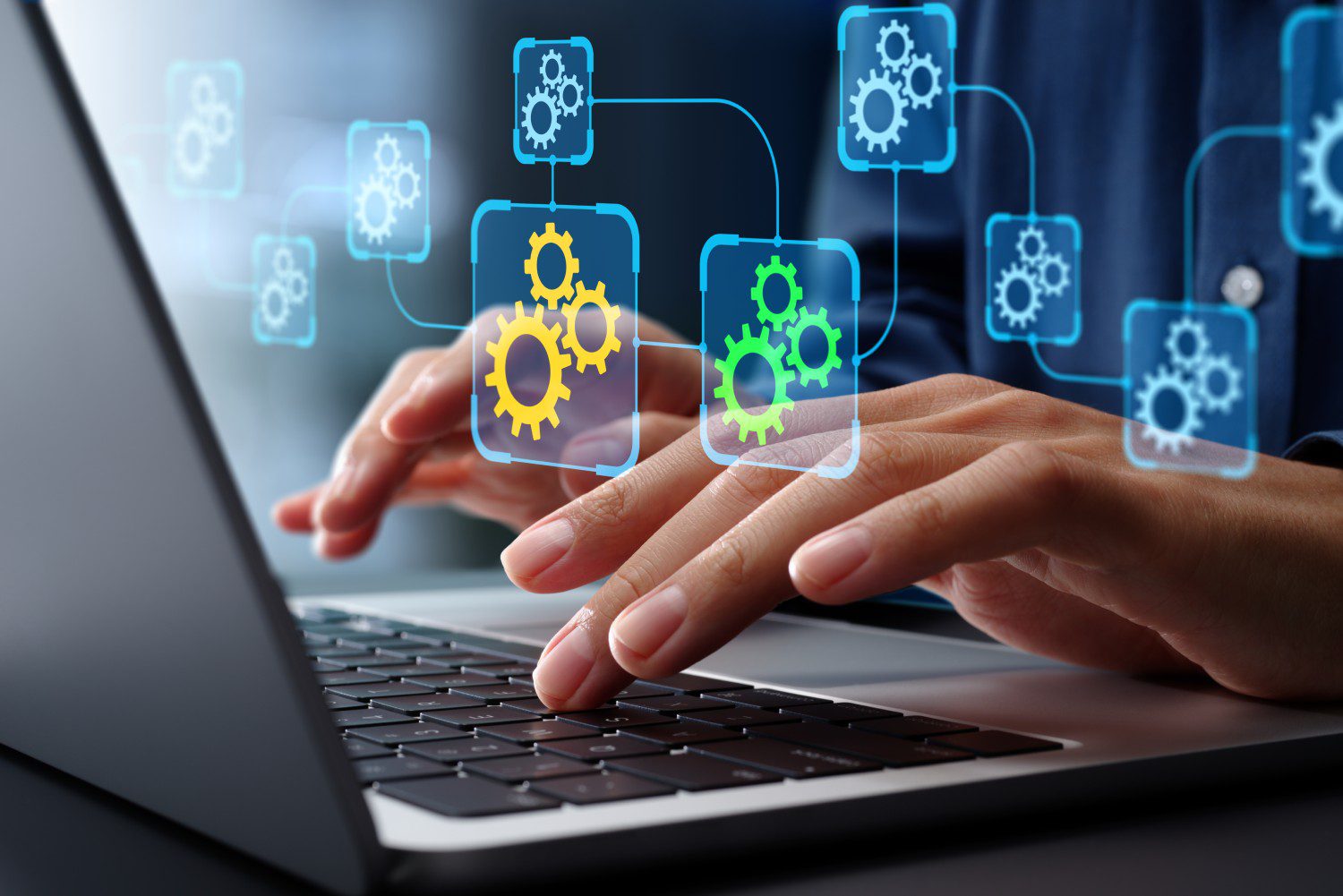 Hands typing on laptop with digital gears.